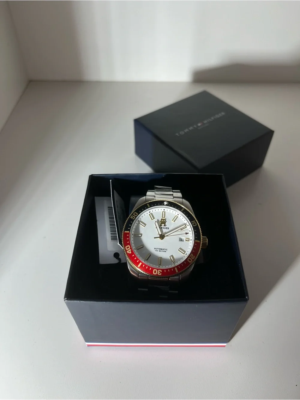 Tommy Hilfiger Silver Dial Men’s Watch with Red and Black Bezel